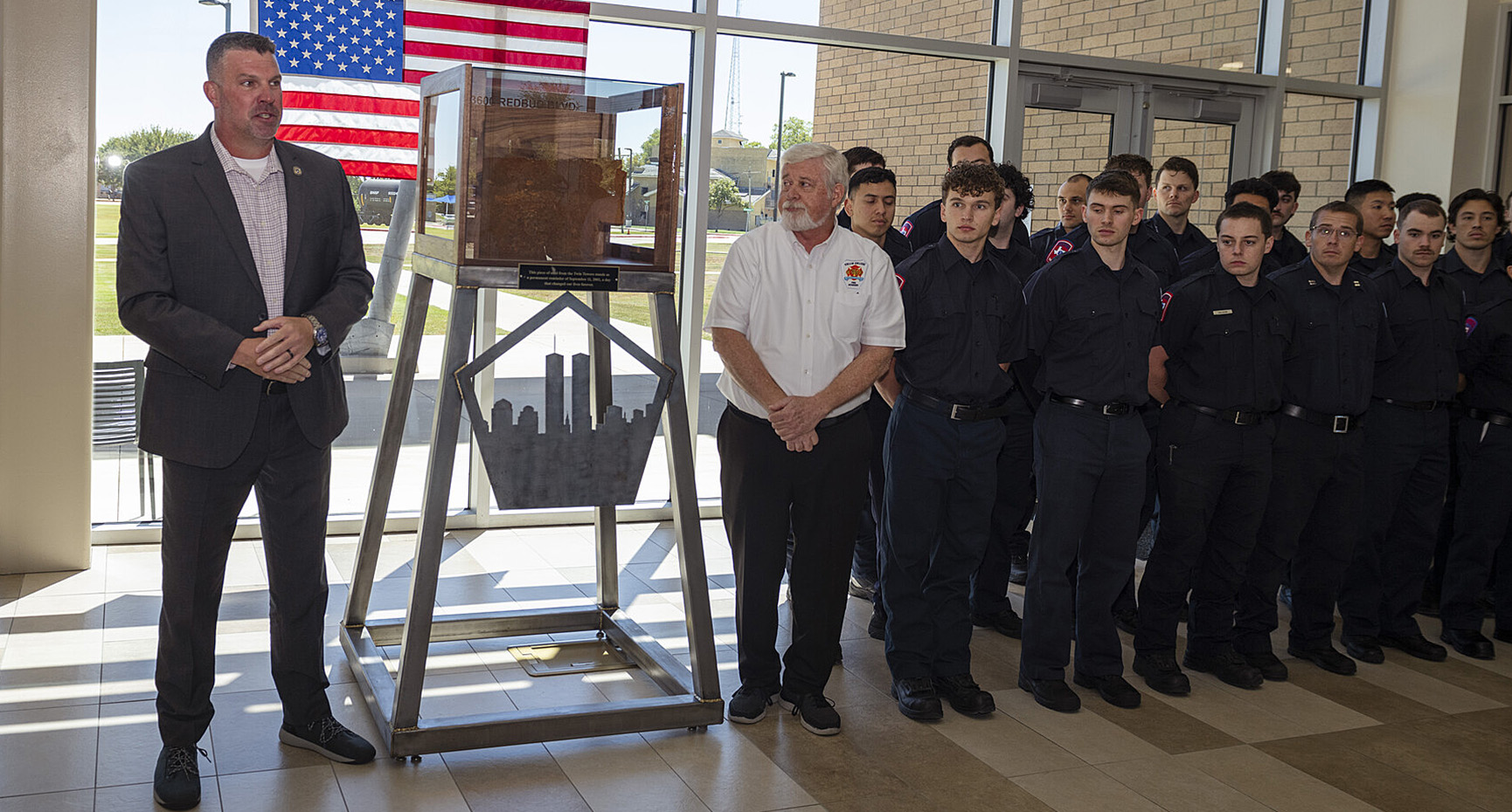 Law Enforcement Academy Director Scott Donaldson (left) and Fire Science Academy Director Pat McAuliff (right) stand next to the Sept. 11 memorial at the Collin College Public Safety Training Center in McKinney.