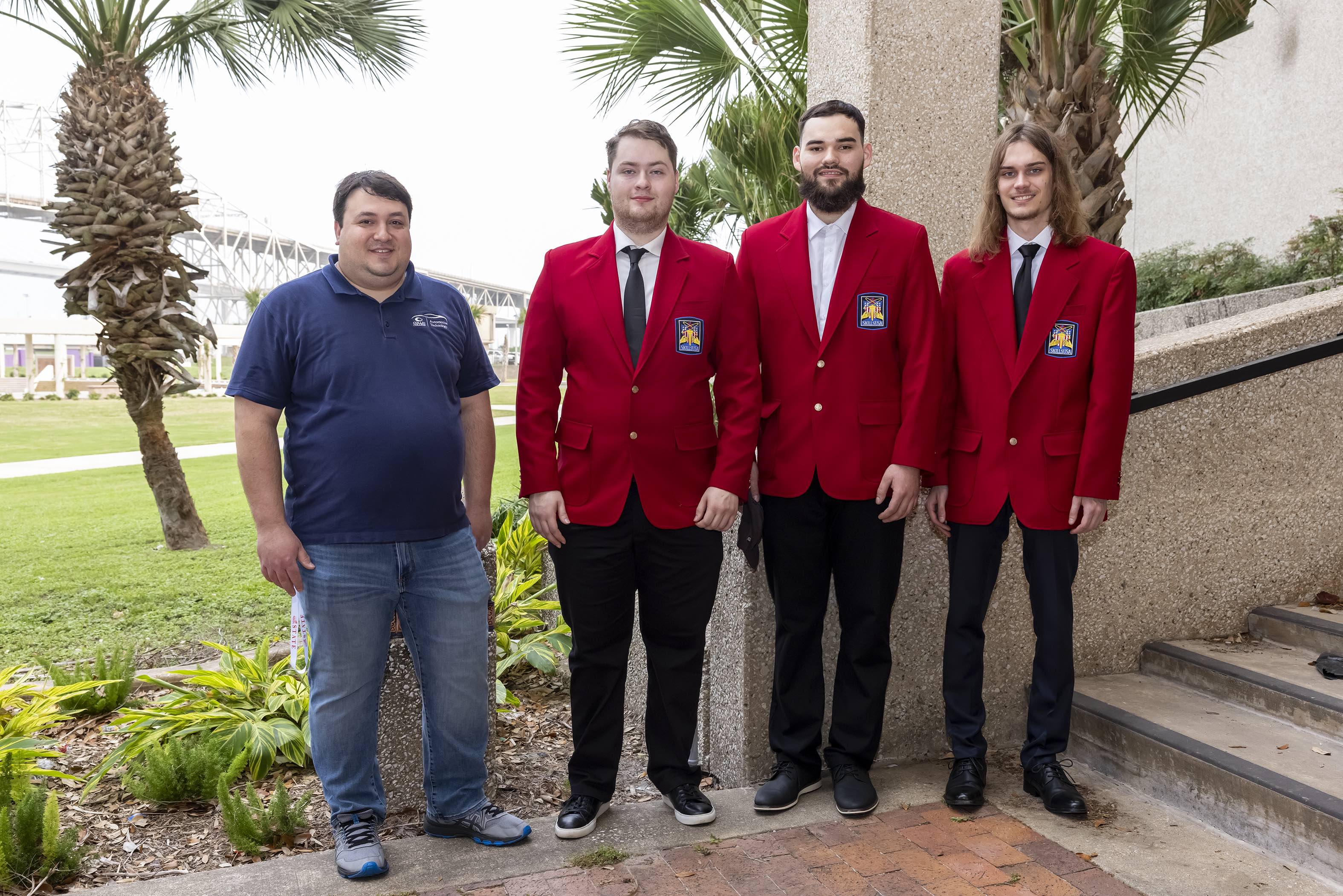 Three students and professor at SkillsUSA competition 