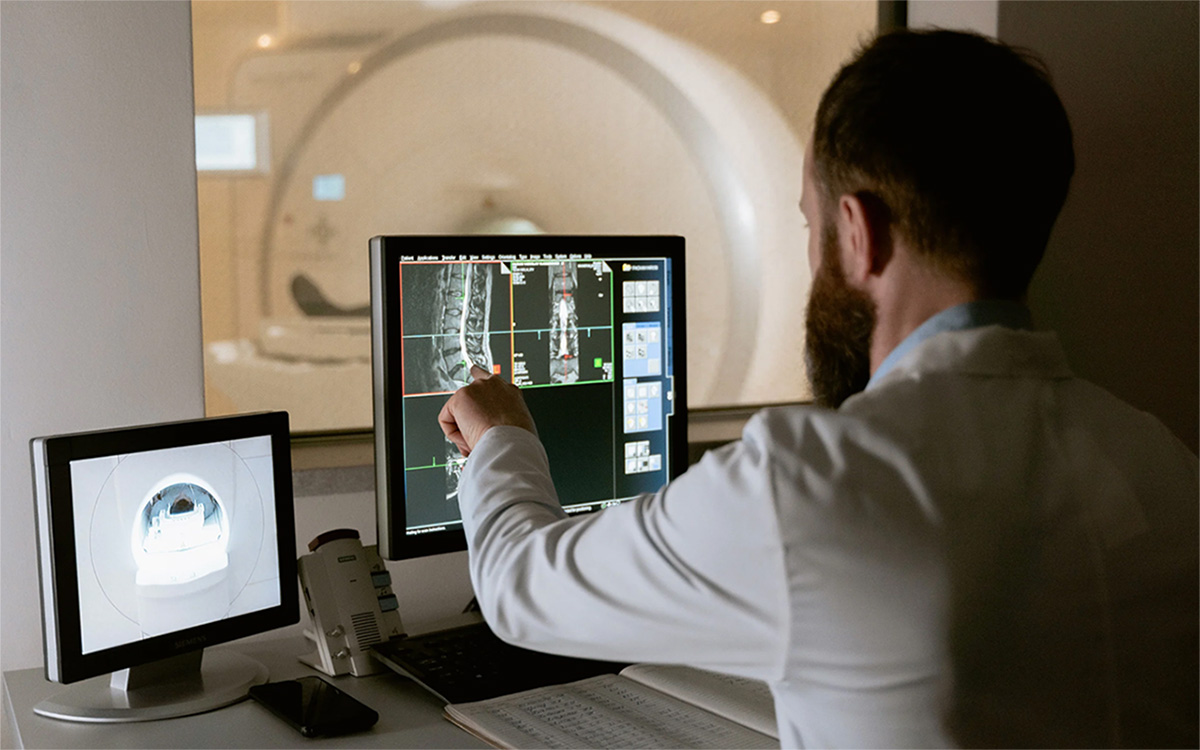 Radiologic Technician reviewing an mri scan.