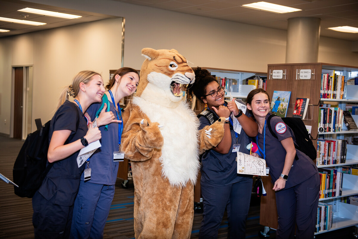 Collin Cougar and Students in the Library