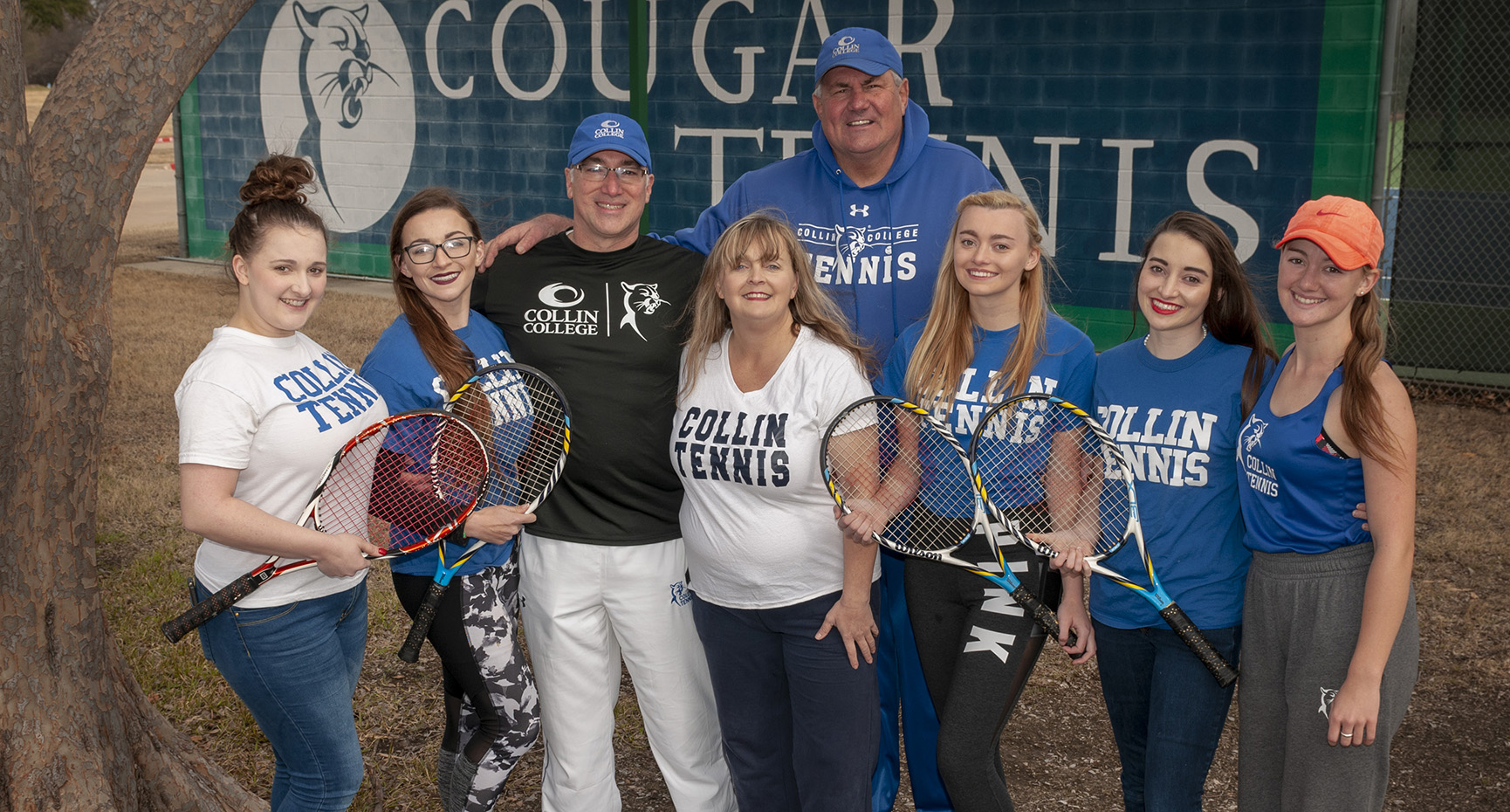 Coach Marty Berryman, center, stands with the Clark family, five members of which played for and earned associate degrees at Collin College. Left to right, Sharon Clark-Heil, Lauren Clark-Justesen, Paul Clark (Father), Melissa Clark (Mother), Berryman, Rachel Clark, Mary Clark, and Rebekah Clark.
