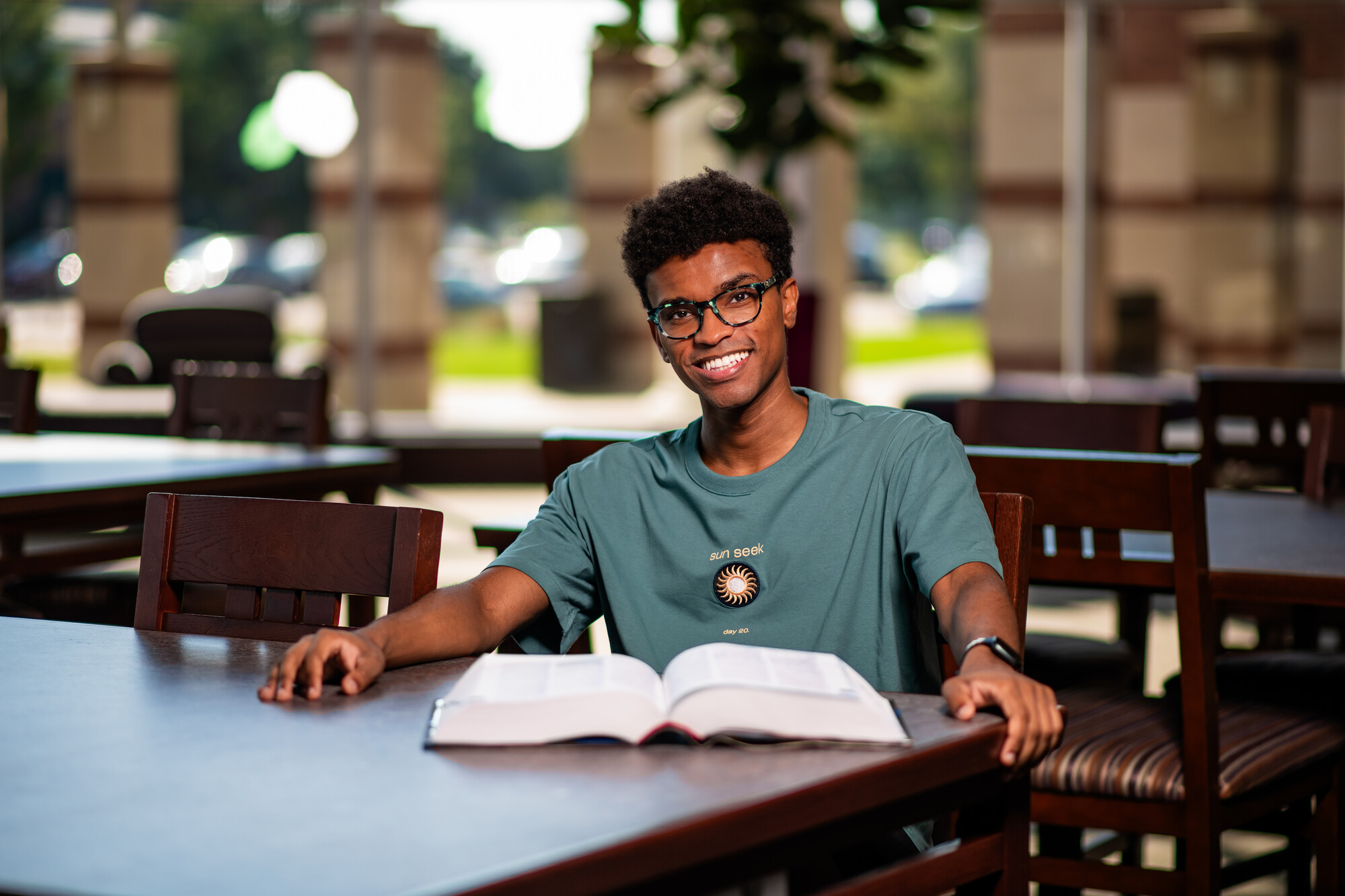 Collin College student Yassin Mudawi at desk