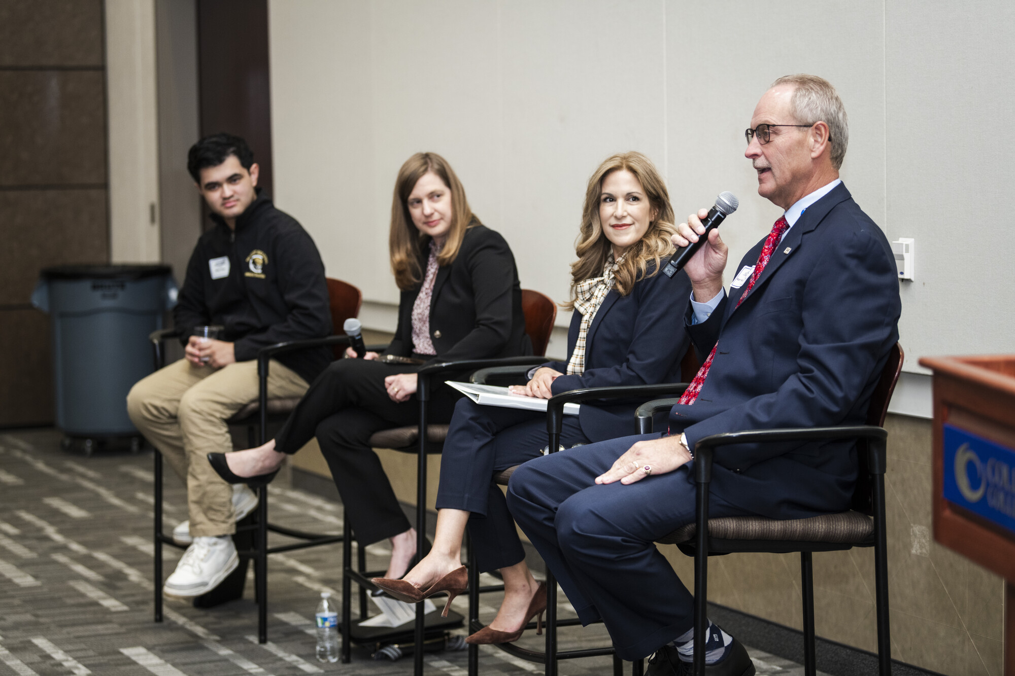 Panelists at The Why Behind Collegiate Academies speak to the audience