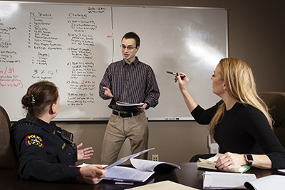 Student intern Marco Trombetta shares information with colleagues.