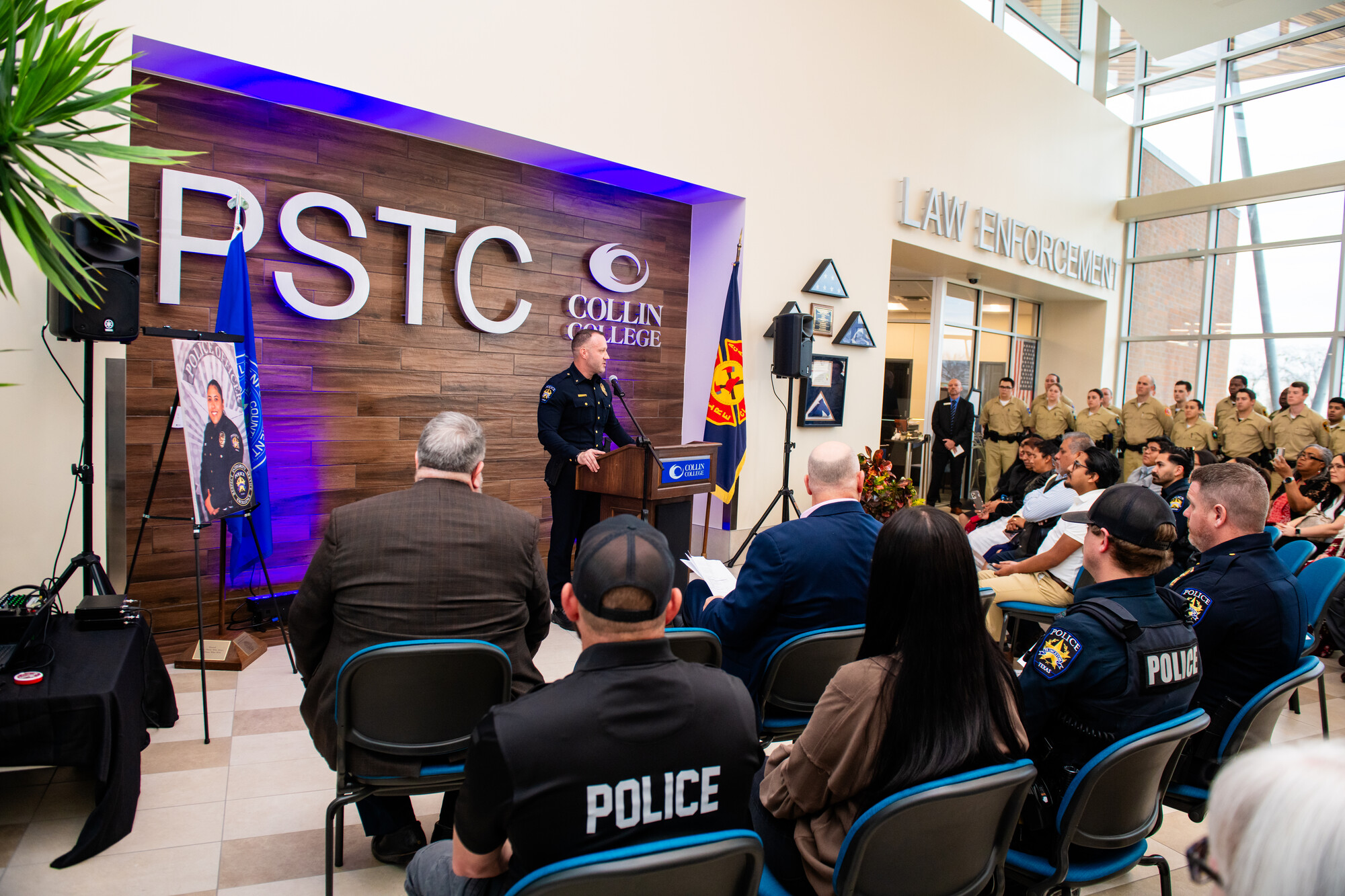 person at podium dressing guests 