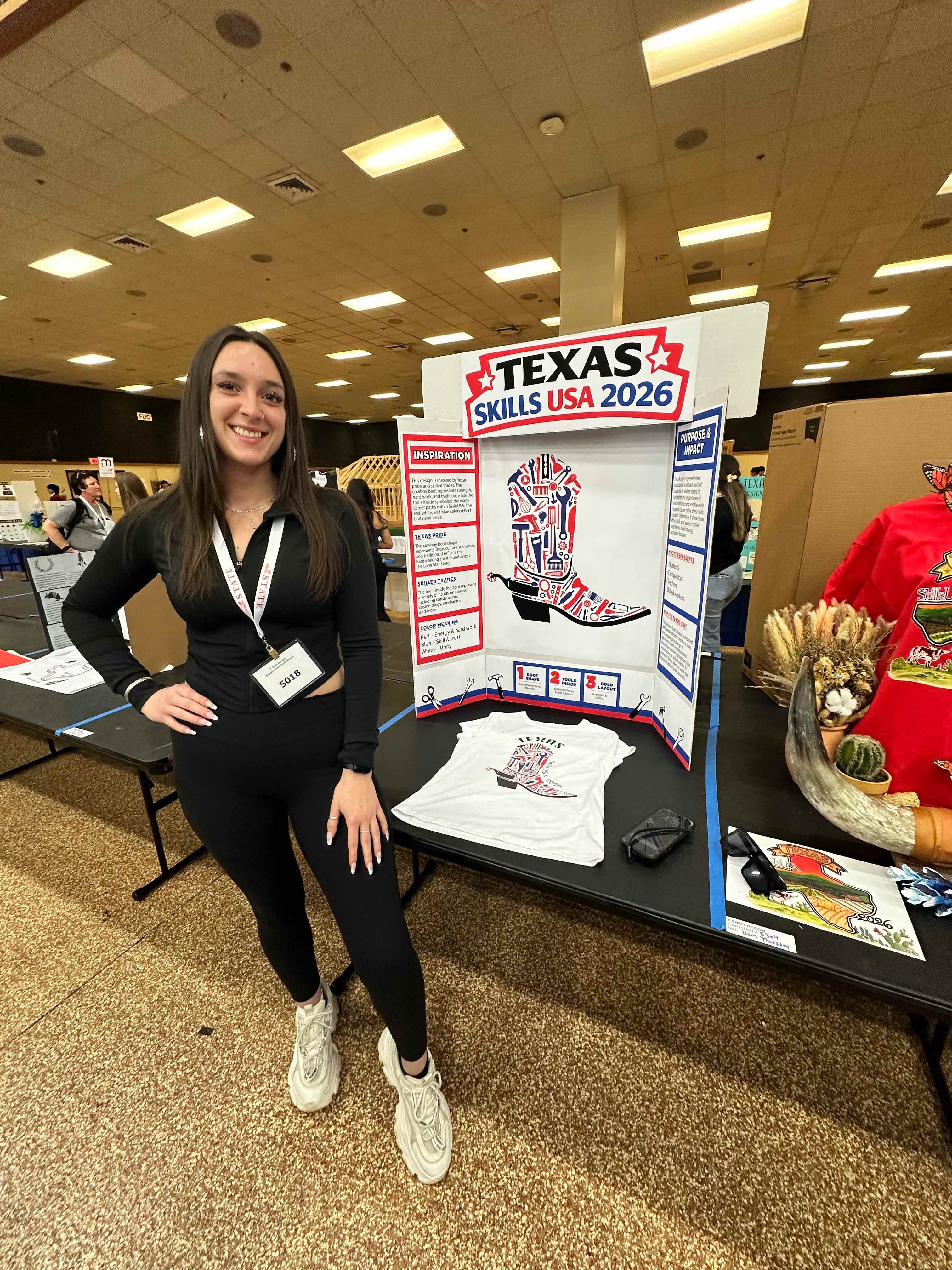 Young woman stands in front of poster with featured artwork. 