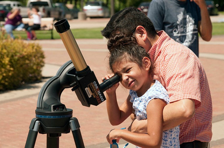 People of all ages take part in a solar eclipse viewing at the McKinney Campus.
