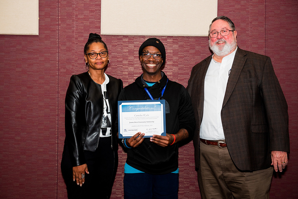 Cornelius Wyche (center with certificate) receives the Jeanna Davis community scholarship at the Dr. Martin Luther King Jr. Power Leadership Breakfast, Jan. 14 at Collin Colleges Plano Campus. Wyche is flanked by Davis, who was also honored at the breakfast for her service to the community, and Collin College District President Dr. Neil Matkin.