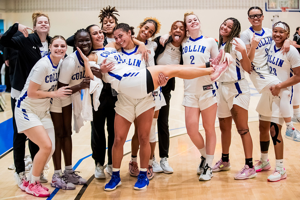The Collin College Lady Cougars celebrate with a group photo after a win against Jacksonville College in January.