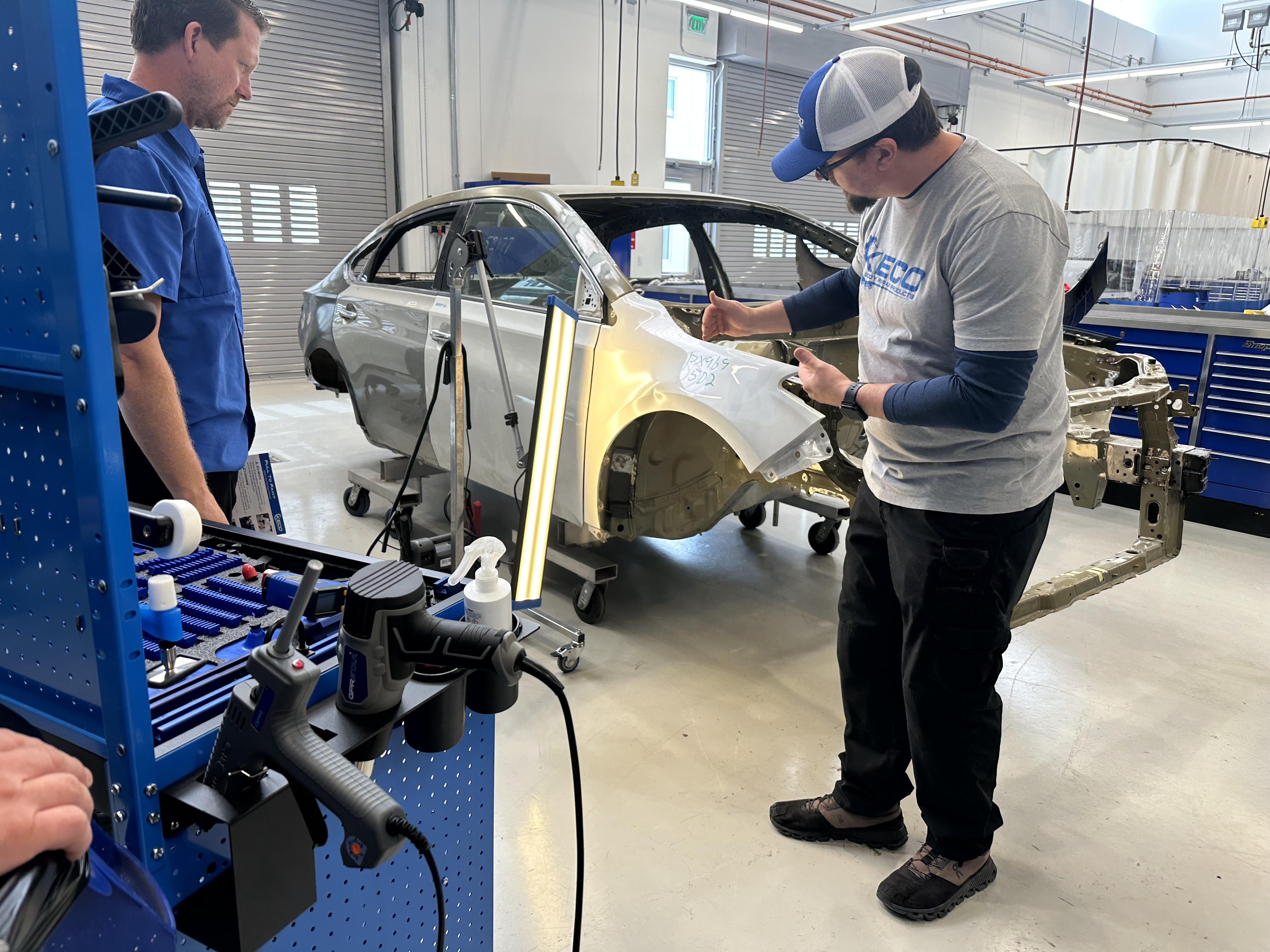 Winferd Vermillion (left), a Collision Technology student, receives training from Christopher Allen of PDR Express. Photo by Raven Hartkopf, Collin College discipline lead and professor of Collision Technology.